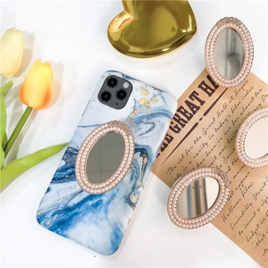 Detail of blue marble phone case with luxury rhinestone pearl mirror phone socket