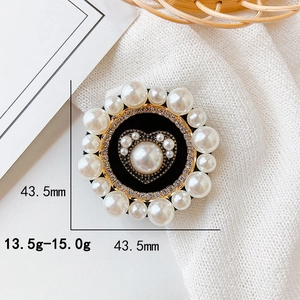 Elegant round pearl phone grip with heart rhinestone center on white linen fabric