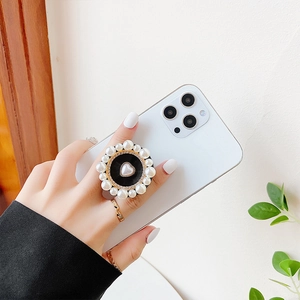 Detail of heart pearl phone grip with sparkling rhinestone border and elegant design