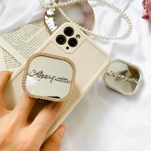Detail of adjustable heart mirror phone sockets with rhinestones in gold and silver