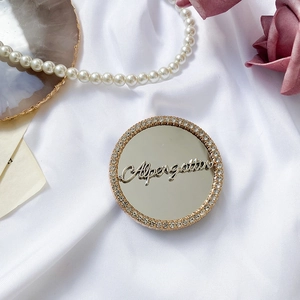 Macro shot of gold rhinestone heart mirror phone socket with Alpenglow engraving