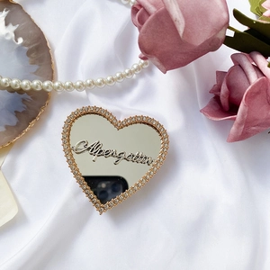 Macro shot of heart-shaped rhinestone phone stand with a mirror finish on silk