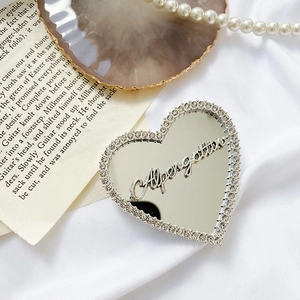 Macro shot of heart-shaped mirror phone grip with rhinestones and Afterglow text