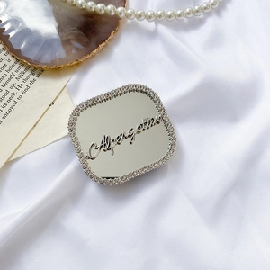 Macro shot of square rhinestone phone socket with heart mirror and golden text