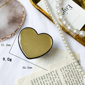 Dettaglio del supporto per telefono a cuore glitter oro con misure 51,2 mm x 46,0 mm