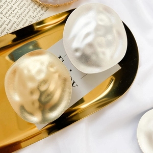Close-up of vintage metallic phone stands with gold and silver hammered texture finish