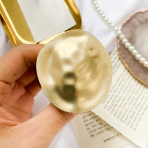 Adjustable matte gold metal phone grip with vintage hammered texture in French luxury style