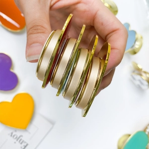 Macro side view of expandable heart phone grips with golden edges and colorful resin finish