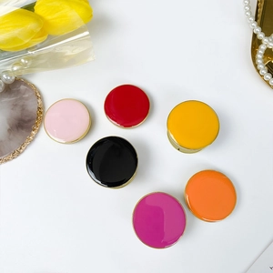 Set of six colorful round folding phone grips with gold edges on a white background