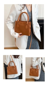 Detail of caramel lychee grain leather bag showing dual handles and adjustable strap