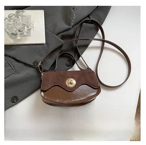 Detail of vintage suede and leather mix handbag with gold buckle and size reference