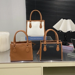 Three elegant tote bags with lychee texture and gold hardware displayed in a modern setting