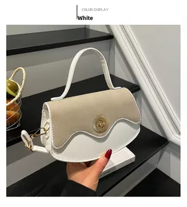 Close-up of the vintage crossbody bag with a wavy flap design and golden metal rotary lock