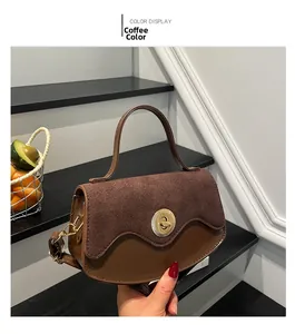 Detail shot of the vintage brown leather and suede stitching with a gold metal twist lock