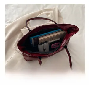 Detail showing the large interior capacity of this wine red glossy leather tote bag