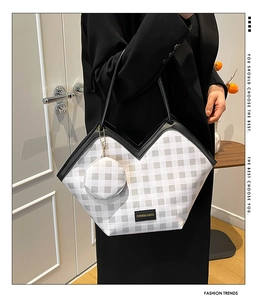 Detail view of checkered tote bag with V-cut design and matching round coin purse