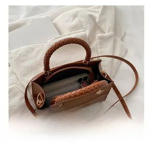 Top view of the brown small square bag showing spacious interior and woven handles