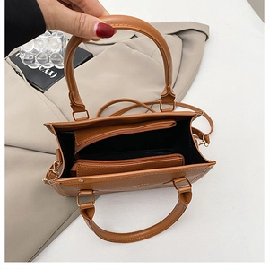 Interior view of brown lychee grain leather tote with zip compartment and shoulder strap