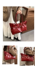Detail of glossy red PU leather tote bag with elegant gold buckle and vintage finish
