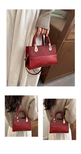 Detail of red faux leather handbag with leopard print panel and gold hardware
