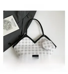 Detail of plaid tote bag with matching round coin purse and black fashion logo patch