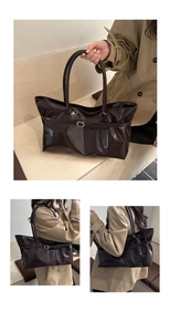 Detail of glossy deep brown patent leather tote bag with elegant gold buckle and dual handles
