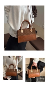 Detail of leopard print handbag with woven handle and gold drop-shaped hardware