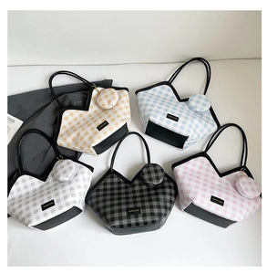 Flat lay of colorful plaid tote bags in five shades with matching mini coin purses