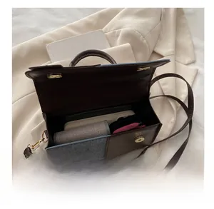 Detailed view of the contrast color square bag showing its large internal storage capacity