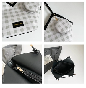 Detail of plaid tote bag featuring fashion tags, zip closure, and small coin purse attachment