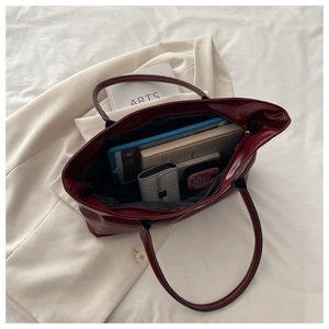 Spacious burgundy bucket bag interior showing large capacity for books and essentials