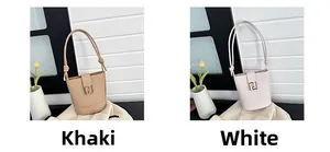 Detail view of khaki and white bucket bags with metal logo and knotted shoulder straps