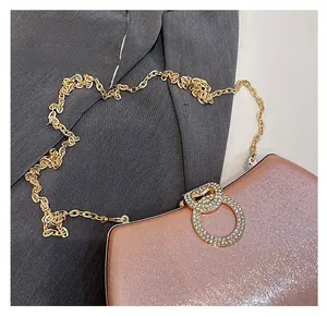 Detail of the champagne gold glitter fabric and elegant rhinestone buckle closure