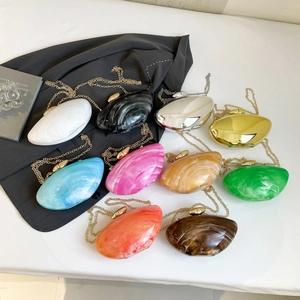 Minimalist acrylic pebble evening bags in nine marble and metallic finishes with gold chain