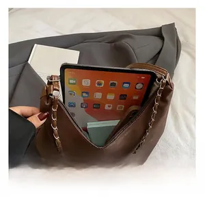 Internal capacity of large brown suede tote bag showing space for tablet and notebook