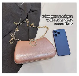 Champagne evening clutch bag size comparison with smartphone showing daily capacity
