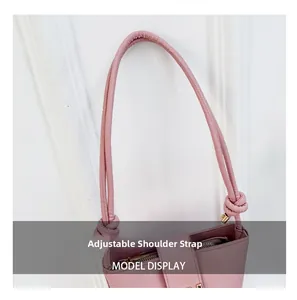 Detail view of pink leather shoulder bag featuring a knotted adjustable shoulder strap