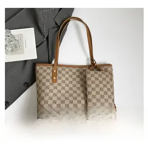 Macro shot of printed canvas tote bag with brown faux leather handles and golden metal buckles