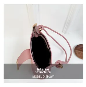 Detailed interior of pink bucket bag showing black lining and zip closure