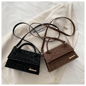 Détail des sacs bandoulière à imprimé léopard en noir et marron avec logo doré chic