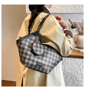 Detail of grey plaid tote bag with matching round coin purse and logo patch