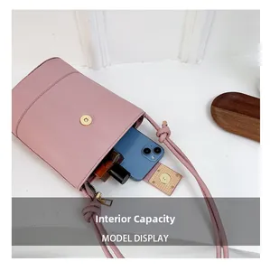 Detail view of pink drawstring bucket bag showing internal capacity and magnetic closure