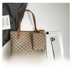 Brown monogram tote bag set with matching coin purse and brown leather straps on grey suit