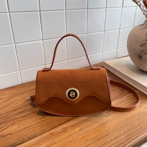 Caramel brown leather and suede crossbody bag with elegant gold circular buckle hardware