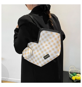 Detail of yellow checkered tote bag with V-cut opening and matching coin purse charm