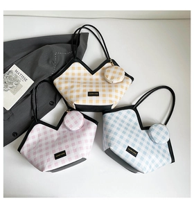 Detailed view of three checkered tote bags in yellow, pink and blue with matching coin purses