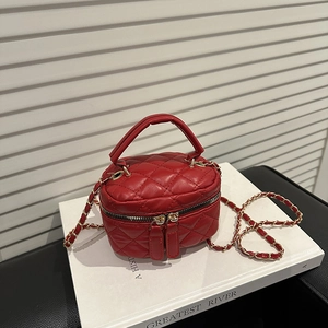 Red quilted chain crossbody bag with top handle and gold zipper for elegant winter fashion