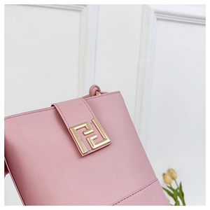 Detail of pink glossy leather handbag showing golden double F buckle and fine stitching