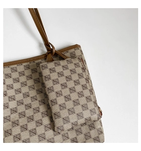 Macro detail of the vintage monogram tote bag featuring leather edge and fine stitching