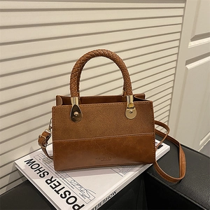 Vintage brown patchwork crossbody bag with woven handle on a white magazine background